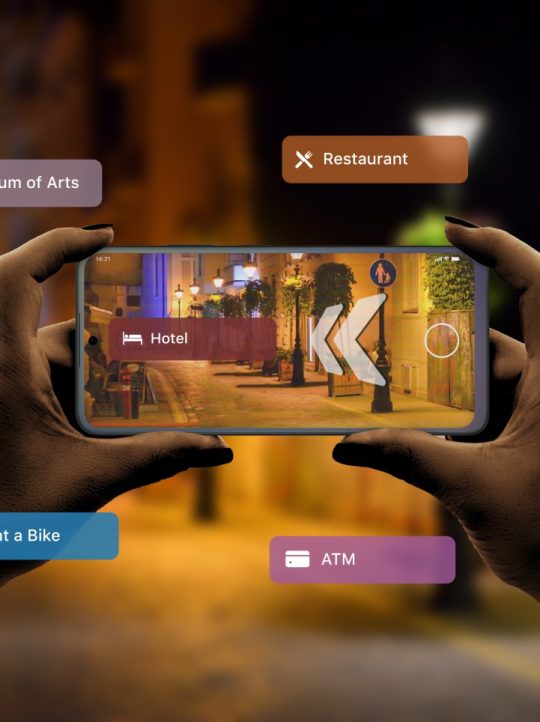 Finding hotels and other tourist facilities in the city with 3d navigation app based on augmented reality technology concept Finding hotels and other tourist facilities in the city with 3d navigation app based on augmented reality technology concept. Smartphone in a horizontal position in the hands of women. City street at night in background
